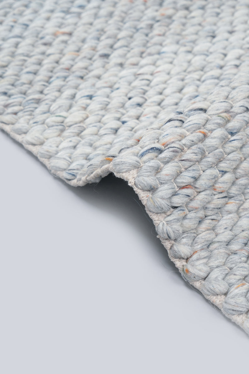 Close-up of hand woven wool texture with watercolour ocean blue tone