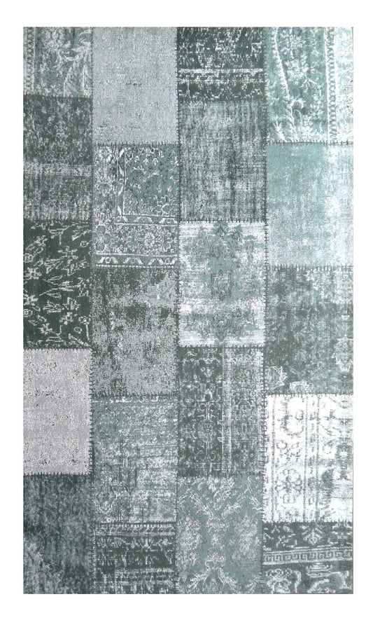 Patchwork area rug with a mix of geometric and floral patterns in shades of green and gray.
